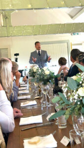 Wedding host entertaining guests at the wedding breakfast